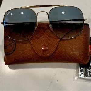 Rayban RB3561 gold sunglasses with blue gradient lenses.